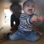 Infants Playing with Cardboards